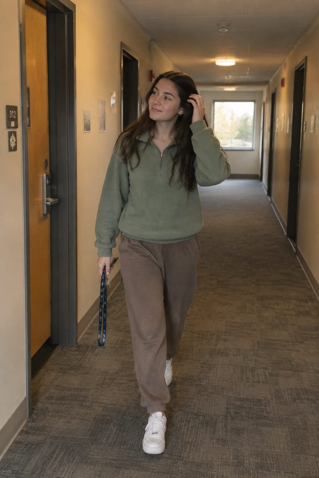 minimal-effort college outfit: green half-zip fleece pullover with taupe fleece joggers and white sneakers
