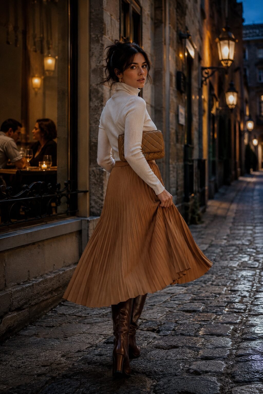 camel and cream date night outfit: fitted cream turtleneck with a fluid camel pleated midi skirt and knee-high boots