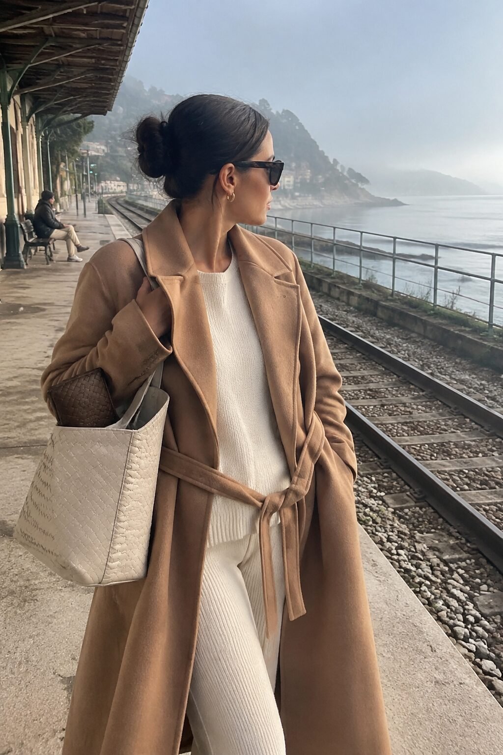 camel and cream travel outfit: belted camel wrap coat over a matching cream knit set