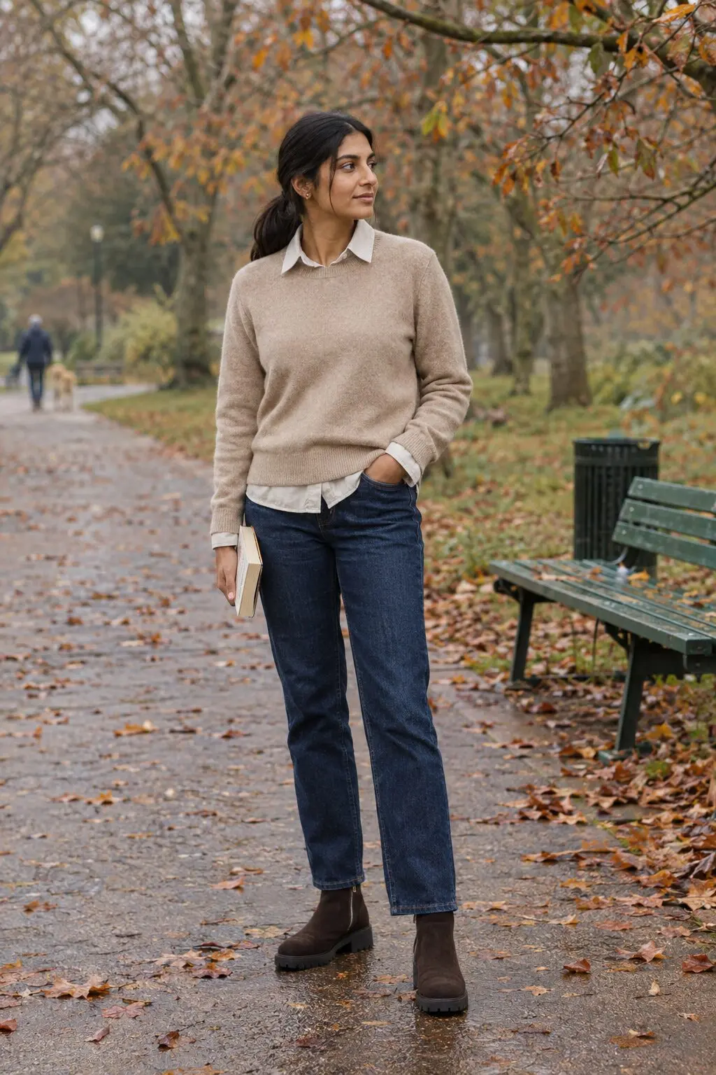 how to style a linen shirt collar and cuffs peeking out from a beige cashmere crewneck with dark-indigo jeans and chocolate suede ankle boots