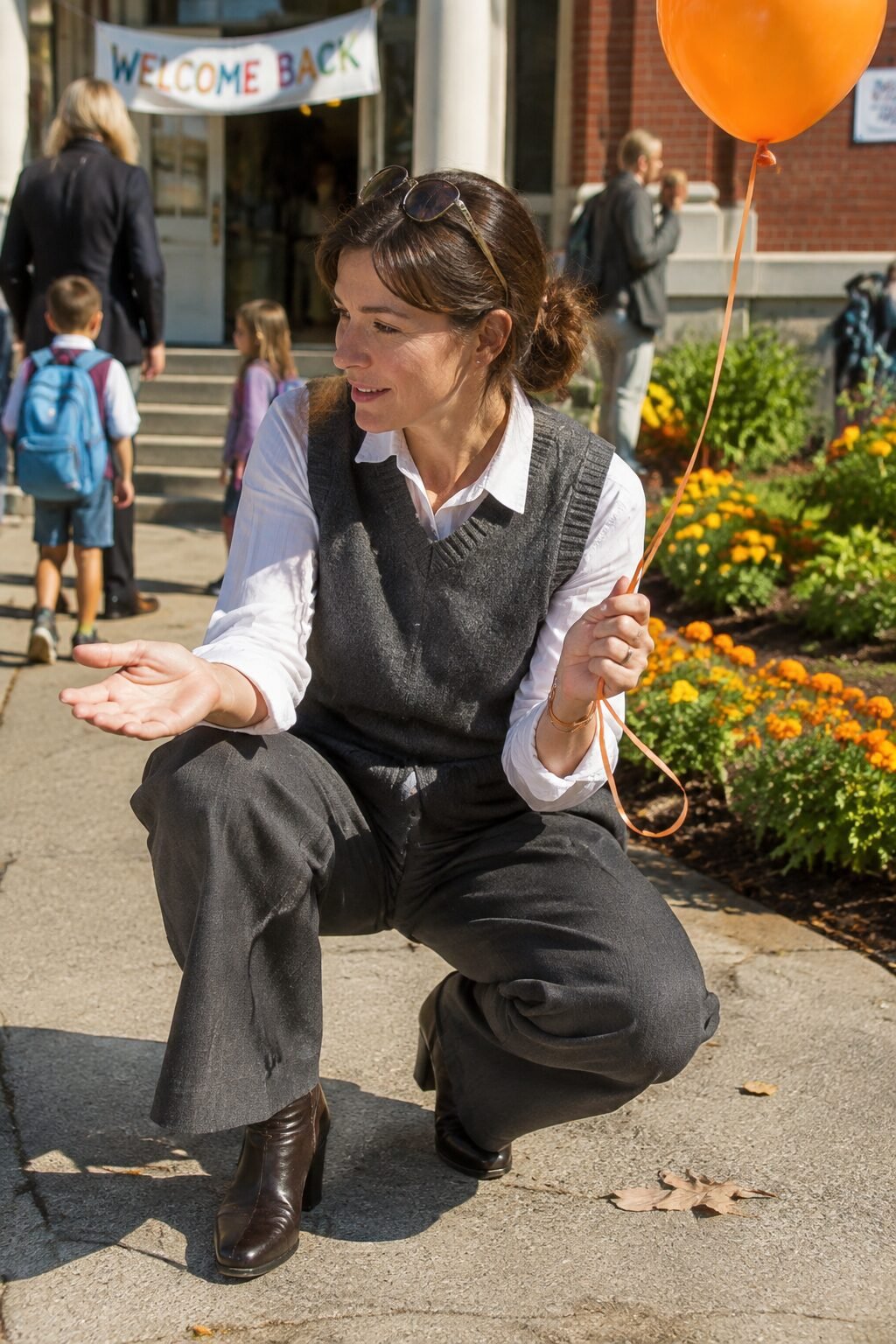 affordable Halloween outfit that looks expensive: charcoal sweater vest layered over a white button-down