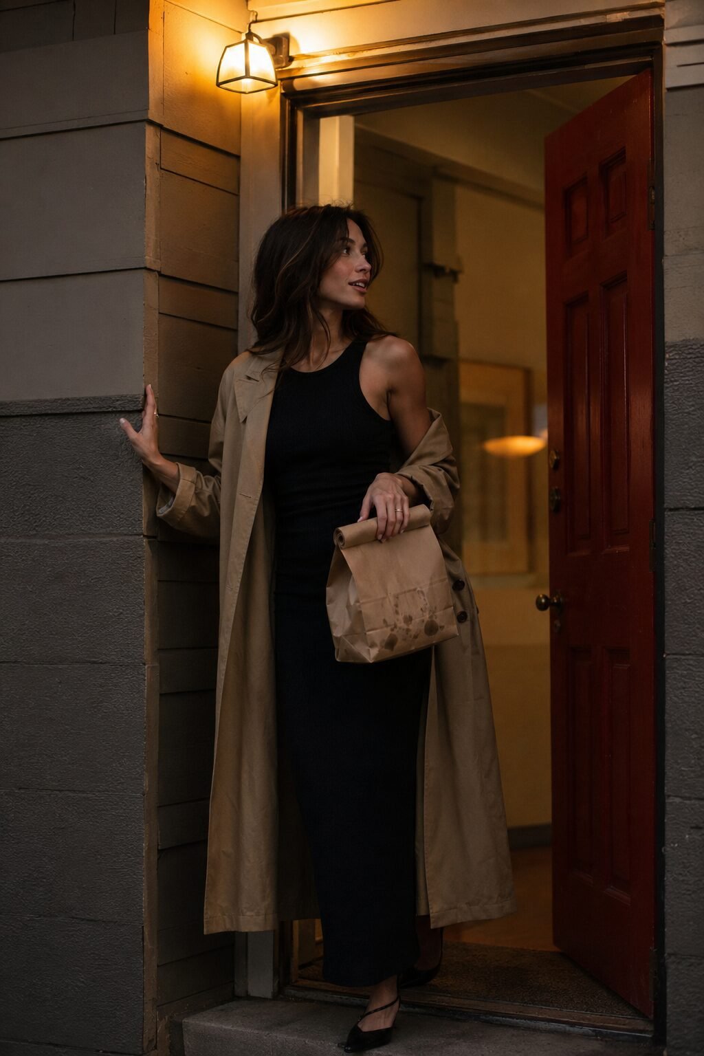 no-effort elegant outfit: black bodycon knit dress with a camel trench draped over the shoulders for date night in
