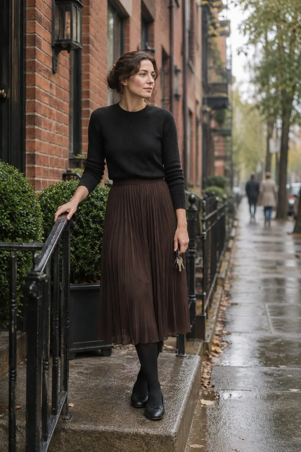 comfortable elegant fall dinner outfit: brown pleated chiffon midi skirt, fitted black cashmere crewneck, black tights and flat shoes