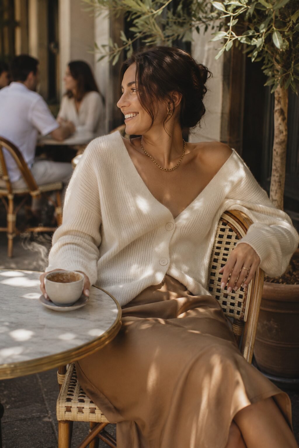 camel and cream brunch outfit: oversized cream cardigan worn open over a camel slip skirt