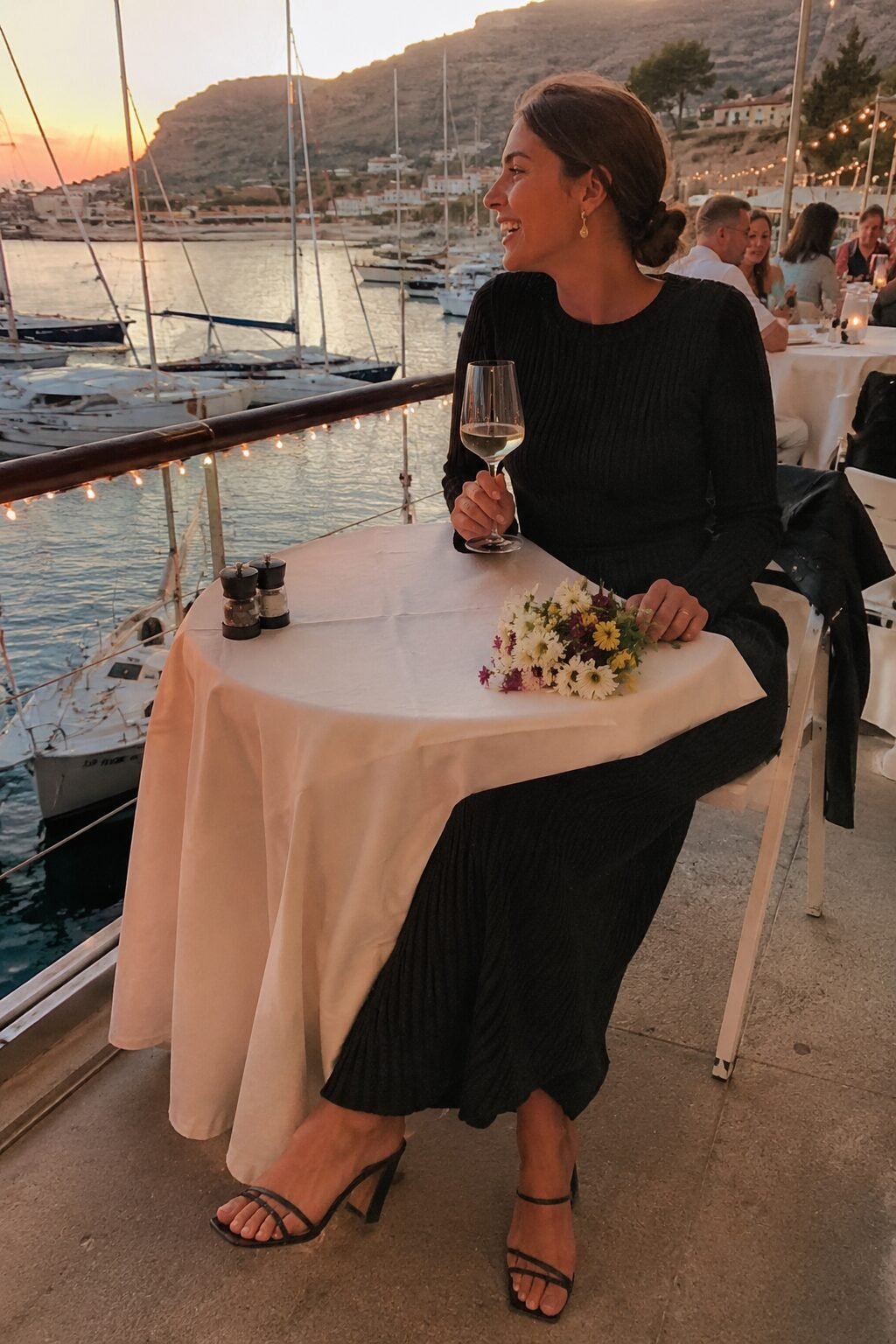 black midi dress with strappy heels and gold earrings, date night outfit