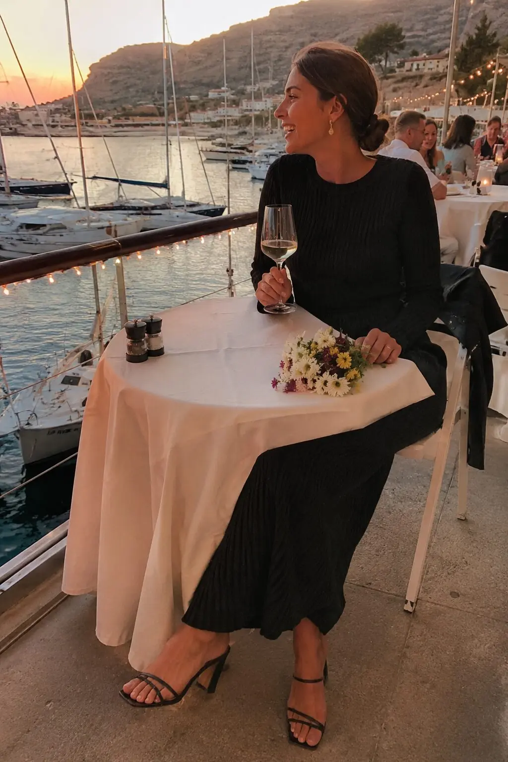 black midi dress with strappy heels and gold earrings, date night outfit