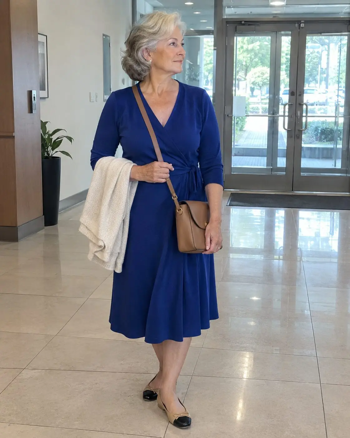 how to style a wrap dress for women in their 70s: navy wrap dress with cashew ballet flats for day and black kitten heels for evening