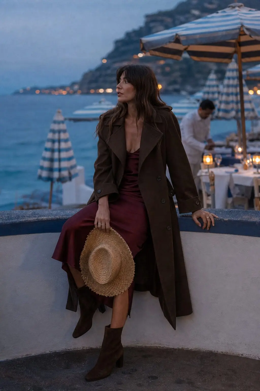chocolate brown trench coat over a burgundy silk slip dress with ankle boots, evening fall capsule outfit