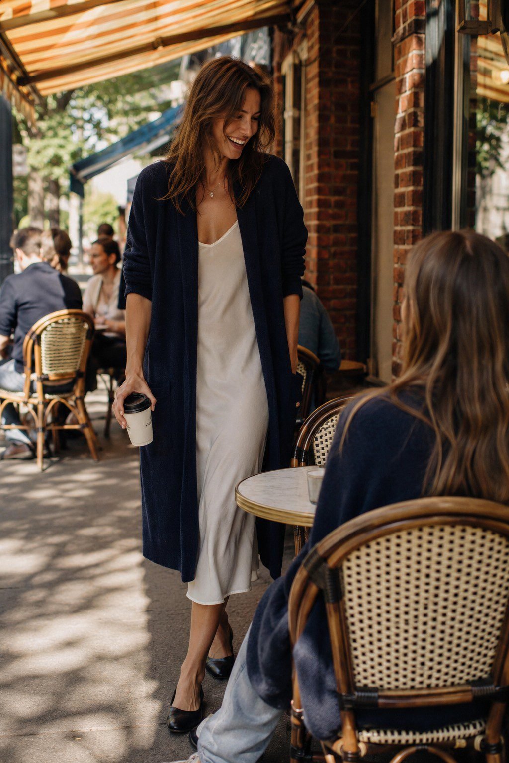 no-effort elegant outfit: navy open cardigan over an ivory slip dress for an impromptu coffee run