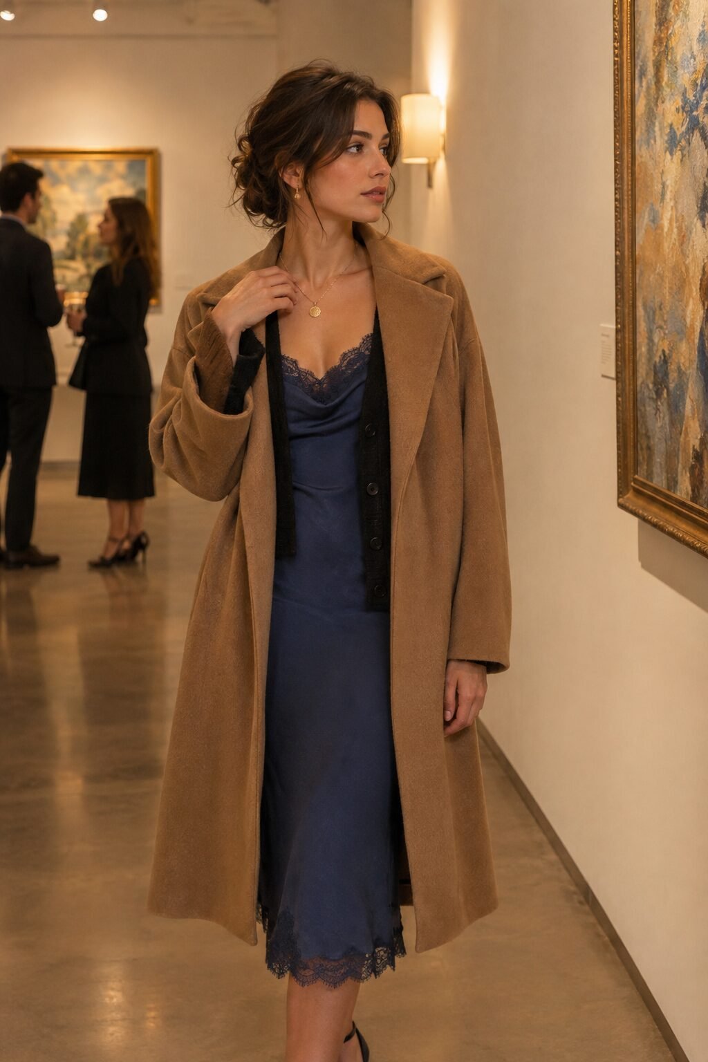 woman wearing a camel wool coat over a slip dress and cardigan for an evening out
