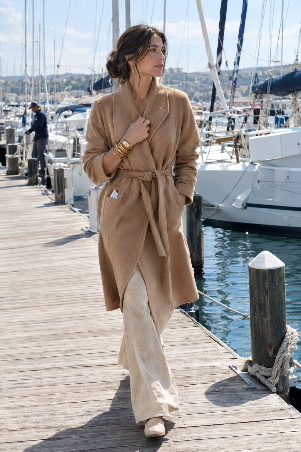 old money outfit with bracelet stacking: camel cashmere wrap coat, flax linen trousers, stacked gold bangles