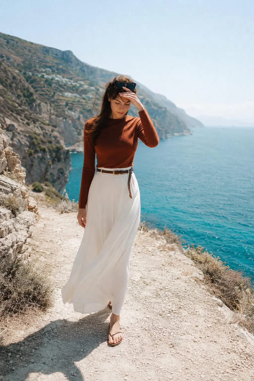 woman wearing a fitted cashmere sweater tucked into a high-waisted maxi skirt