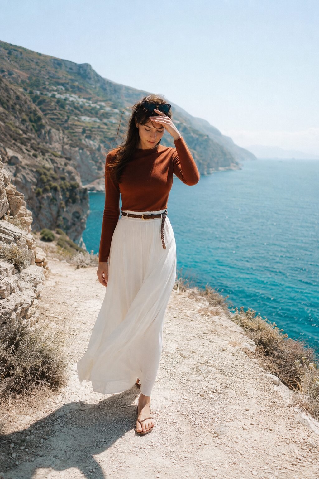 woman wearing a fitted cashmere sweater tucked into a high-waisted maxi skirt
