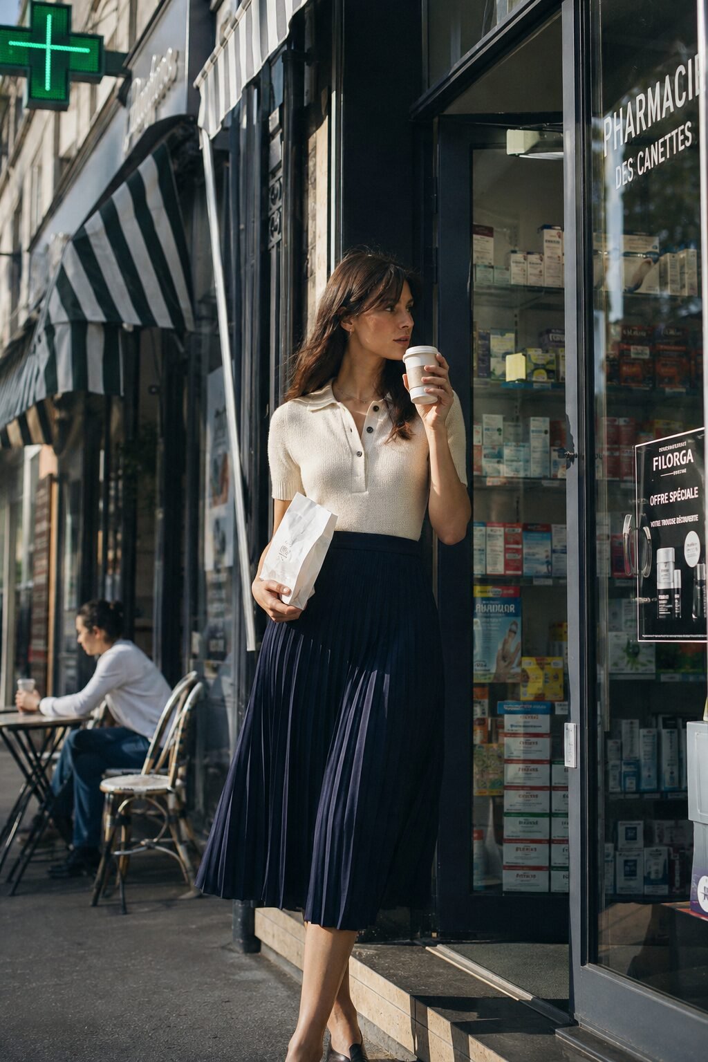 elegant errand day outfit: cream knit polo tucked into a navy pleated midi skirt