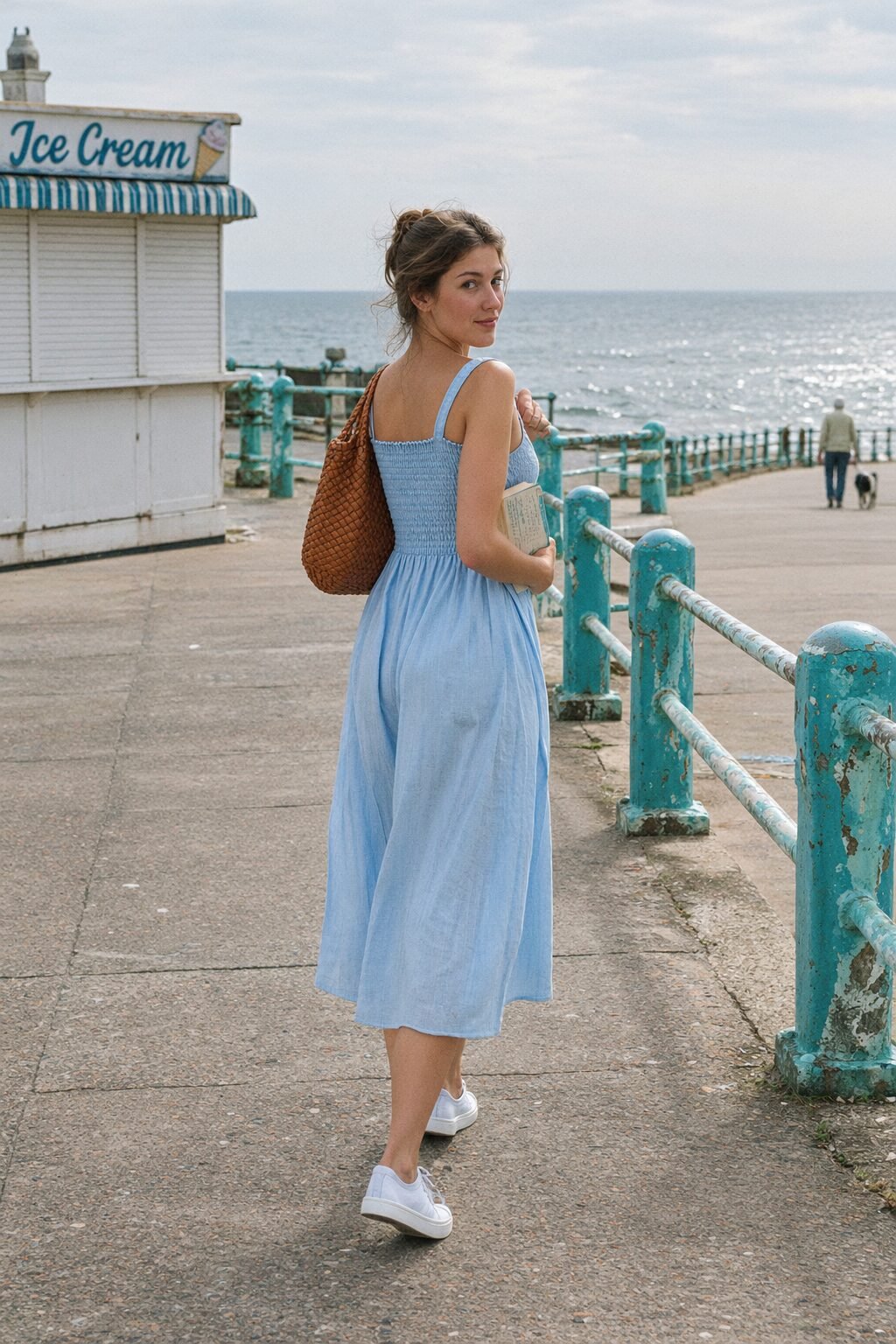 old money dress outfit: powder blue smocked cotton midi dress with white leather sneakers and a woven cognac leather shoulder bag