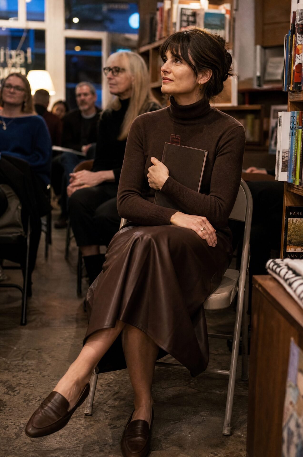 dark academia evening outfit: rich brown cashmere turtleneck sweater tucked into a chocolate faux leather wrap midi skirt