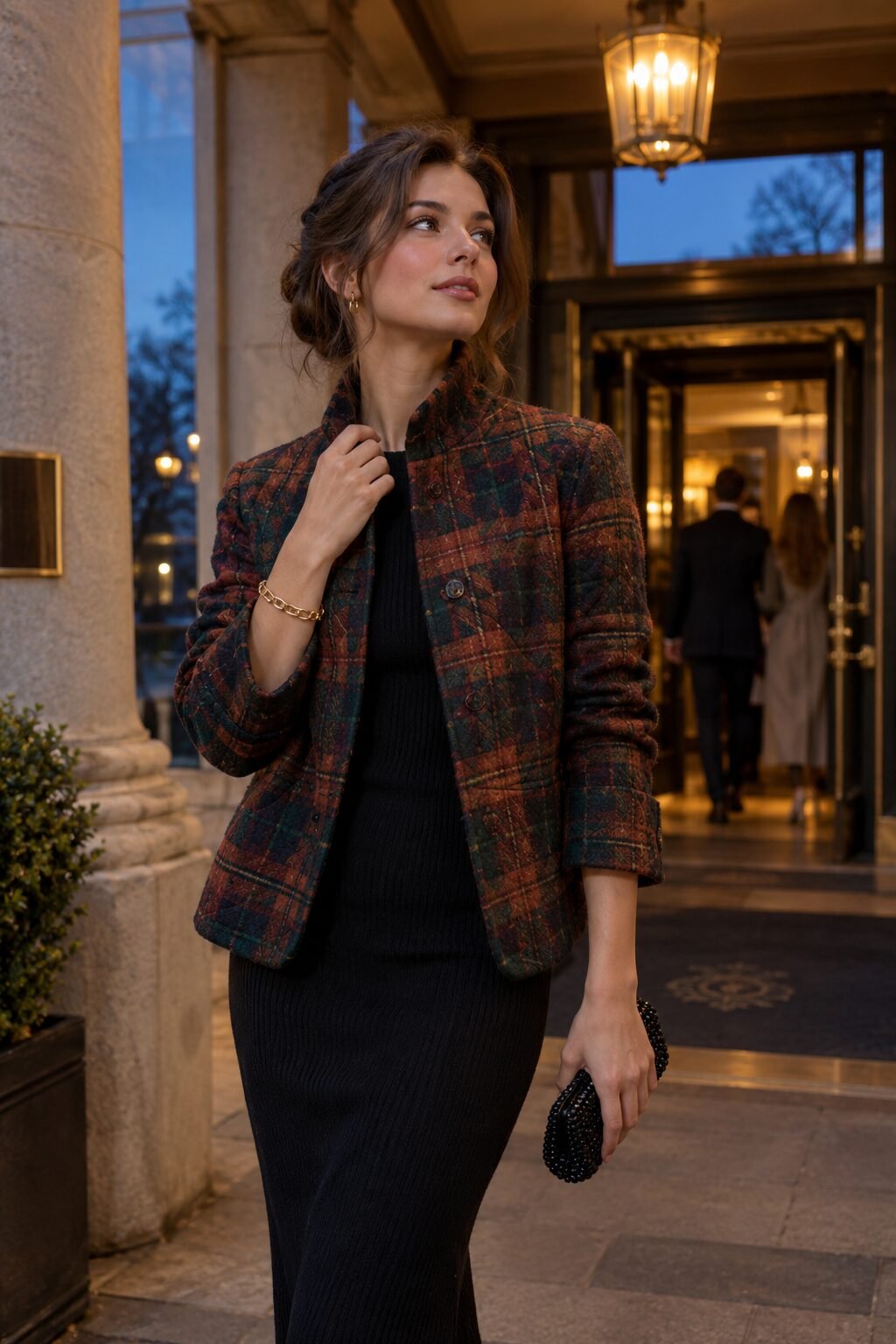 old money bracelet stacking outfit: quilted tartan jacket over black ribbed knit dress, gold chain bracelet