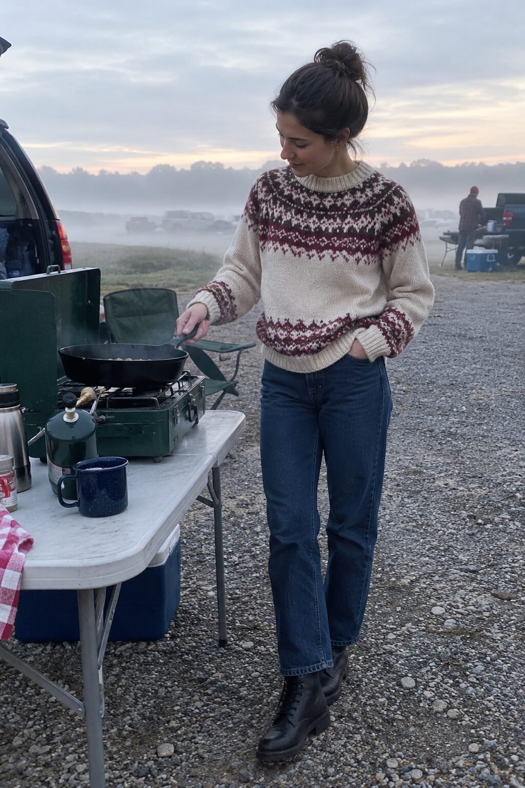 cozy old money tailgate outfit: cream and burgundy fair isle sweater, straight denim, and black lace-up leather boots
