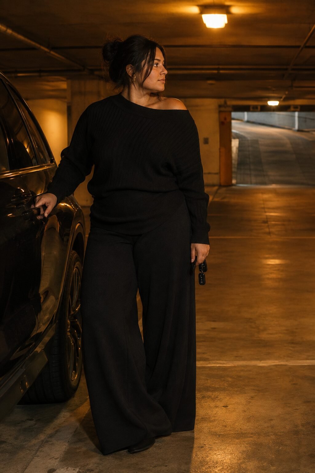 plus size halloween dinner outfit: black knit sweater with fluid black wide-leg trousers
