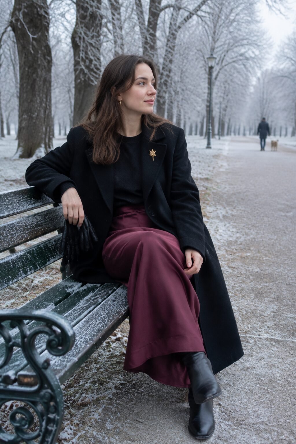 black Italian wool coat and burgundy crepe slip skirt winter walk outfit with a brooch pinned to the coat's lapel