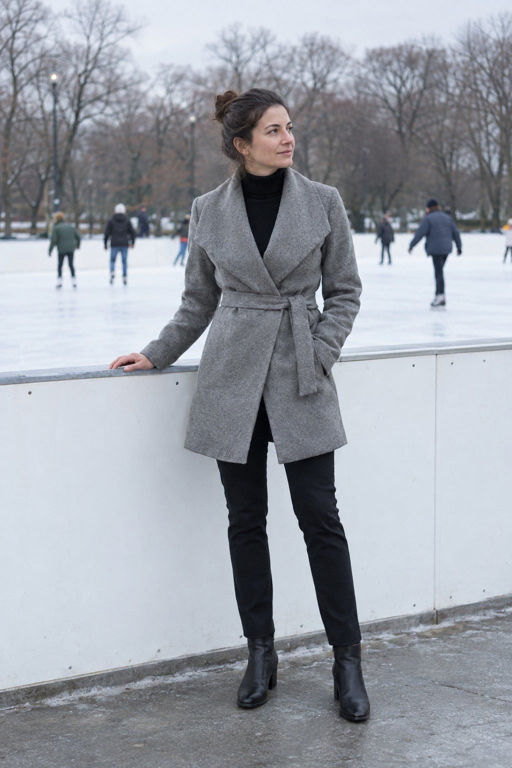 cool toned winter outfit: black cashmere turtleneck under a heather grey wrap coat for outdoor ice skating