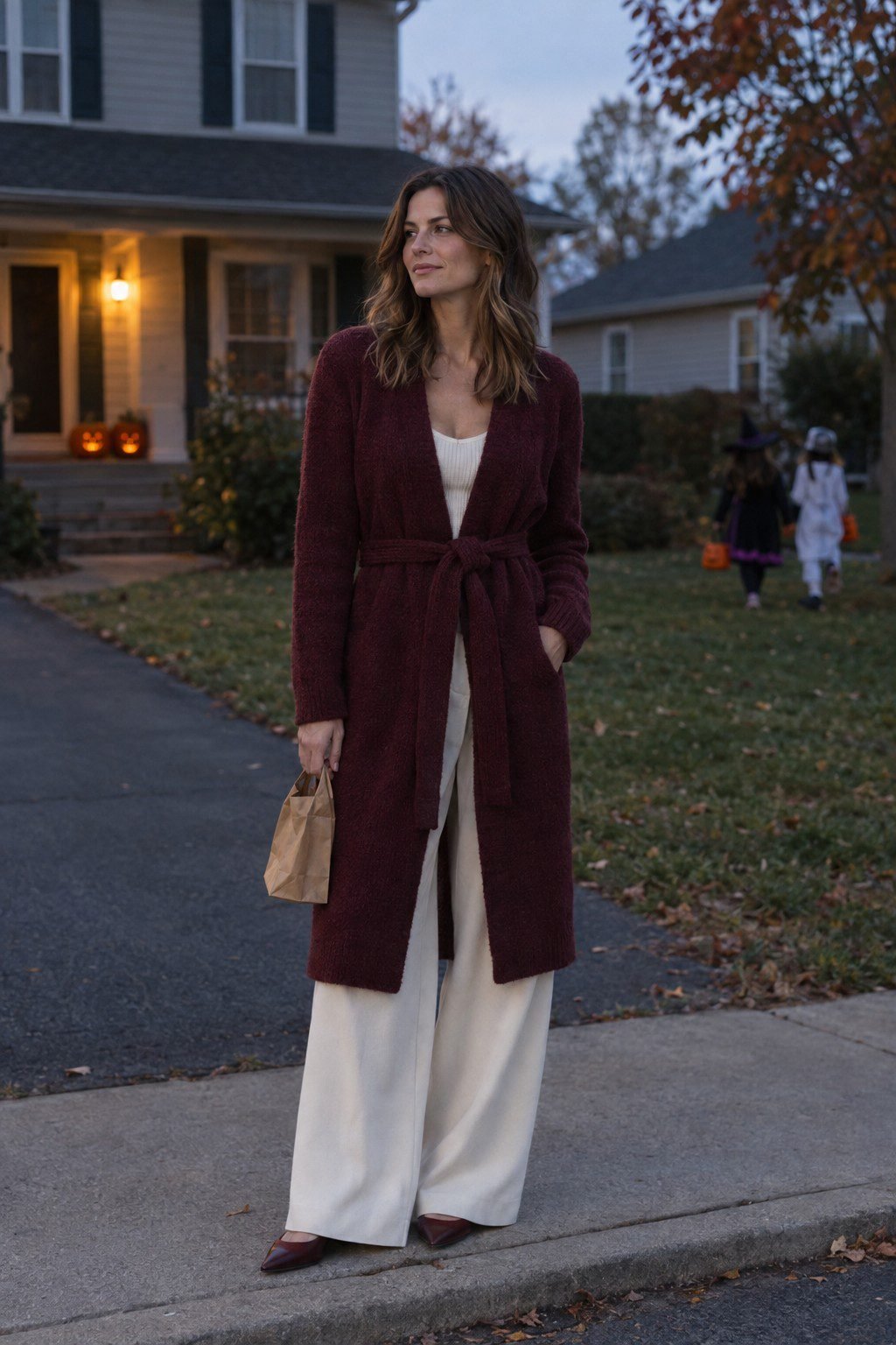 burgundy long open cardigan-coat over an ivory ribbed tank and wide-leg trouser, elegant halloween outfit for moms trick-or-treating