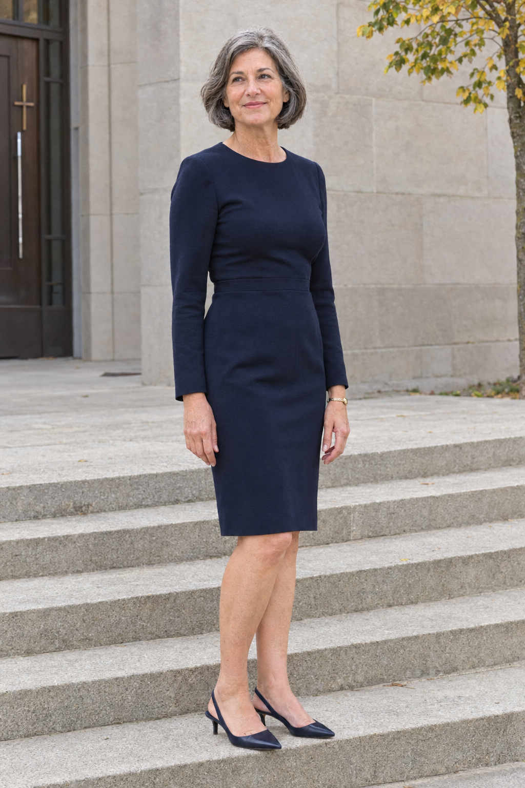 mother of the bride outfit in navy: long-sleeve knee-length sheath dress with navy kitten-heel slingbacks