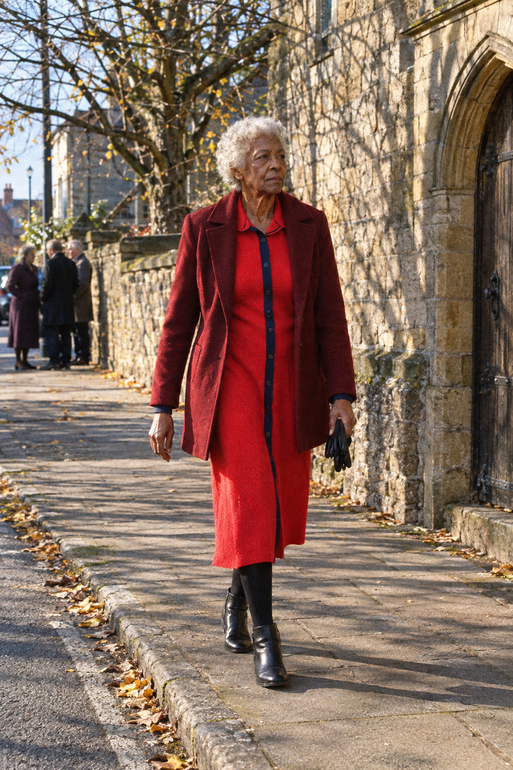elegant church outfit for a woman in her 80s: red knitted mid-calf shirt dress, open wine wool coat and black side-zip ankle boots