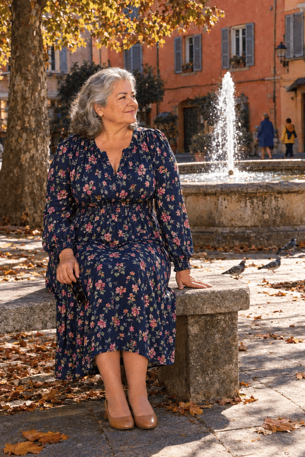 plus size outfit for women in their 70s: navy floral-stamp long-sleeve jersey midi dress with a smocked waist and tan block-heel pumps