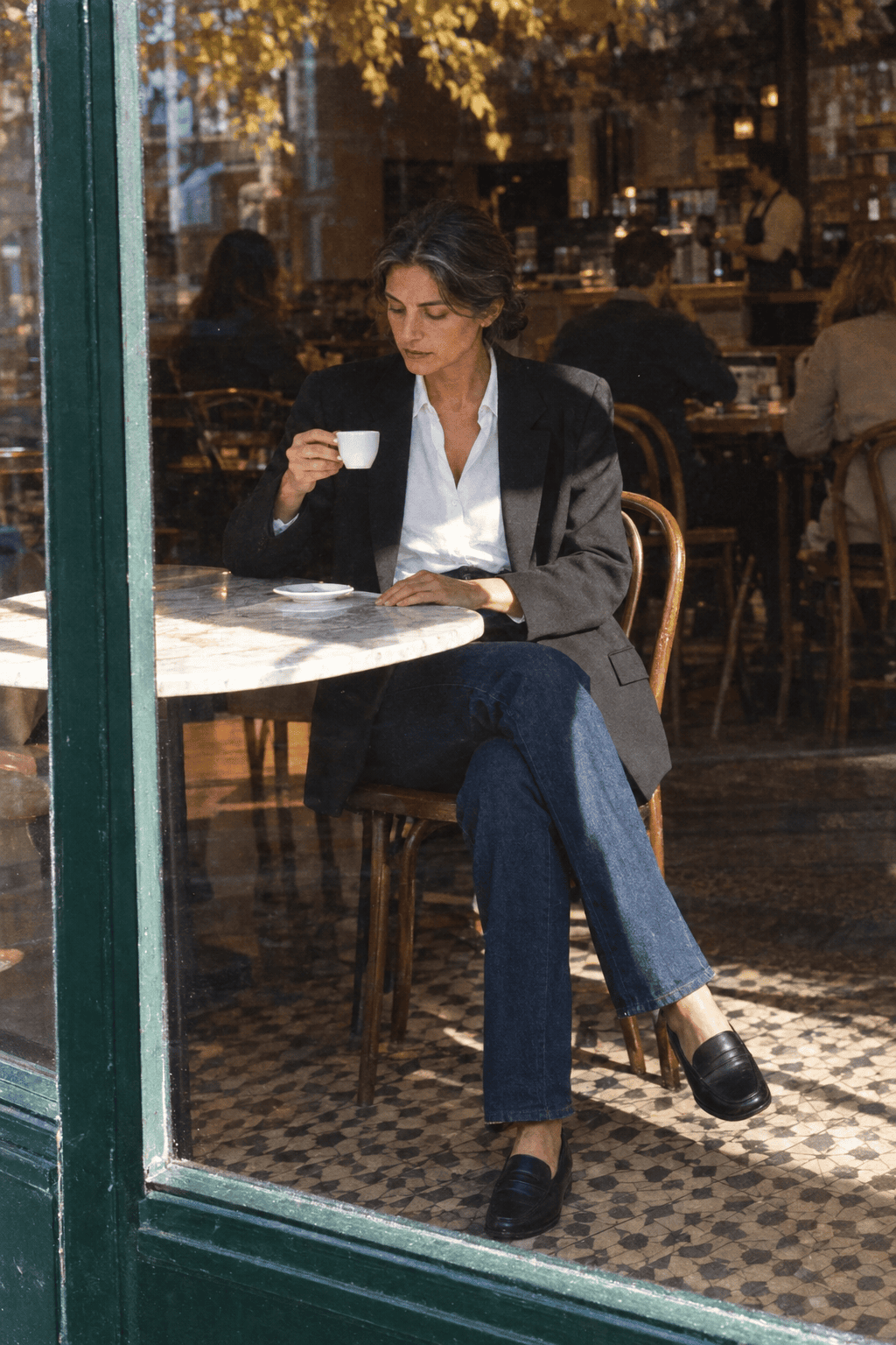 Massimo Dutti quality review: woman in a dark wool blazer and white cotton shirt at a cafe table