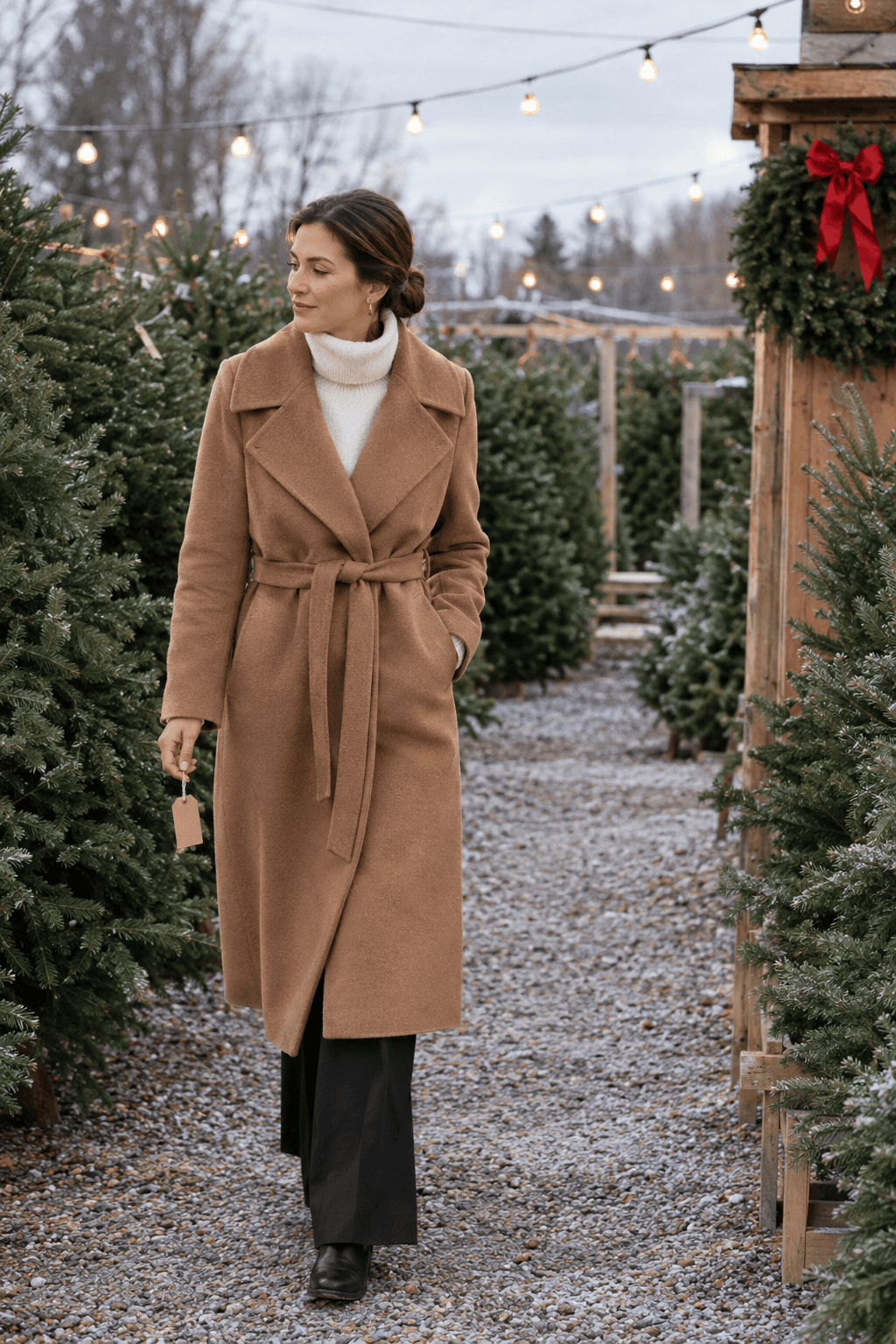 christmas capsule wardrobe tree lot outfit: caramel wrap coat, winter white turtleneck, black wide-leg trousers and black leather ankle boots