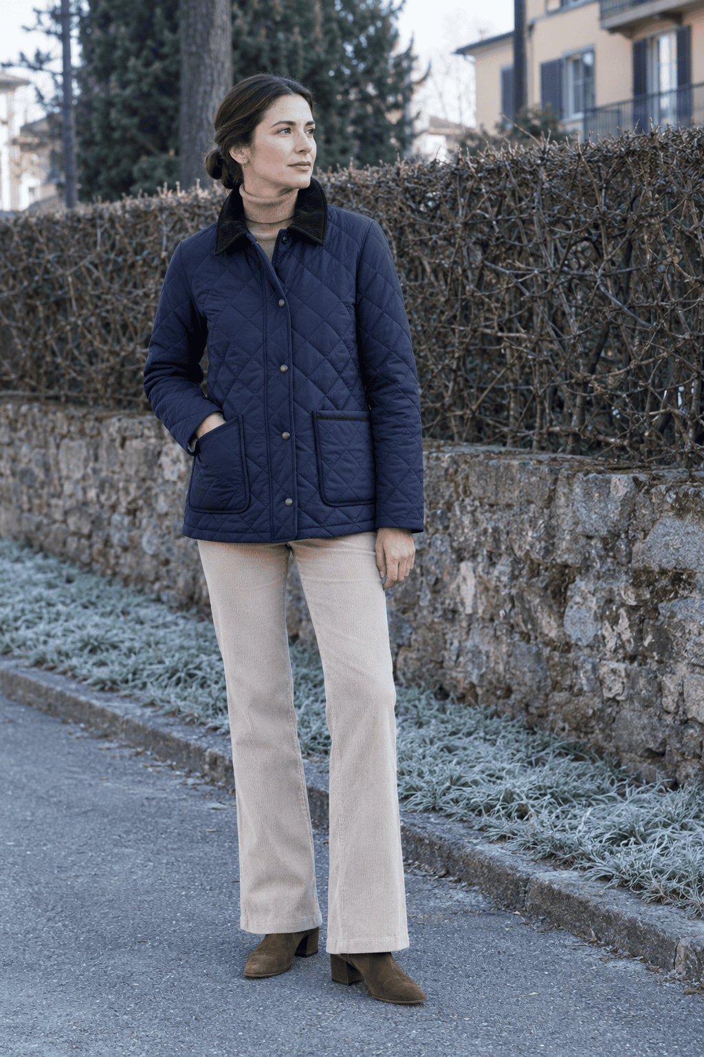 old money milan weekend outfit: navy diamond-quilted jacket with corduroy collar, camel cashmere turtleneck, stone corduroy trousers and brown suede ankle boots
