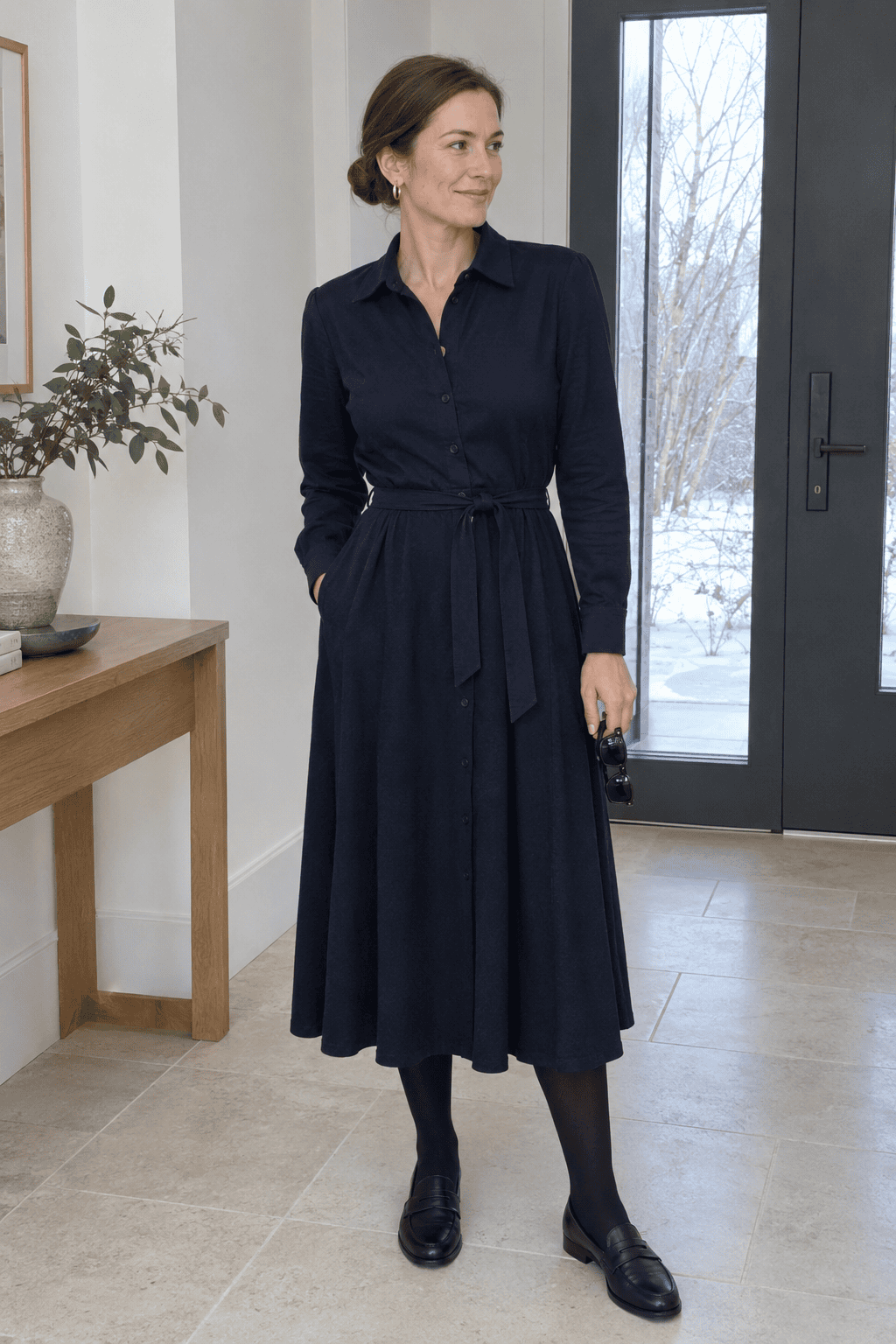 woman wearing a dark long-sleeved dress, one versatile occasion dress for a capsule wardrobe
