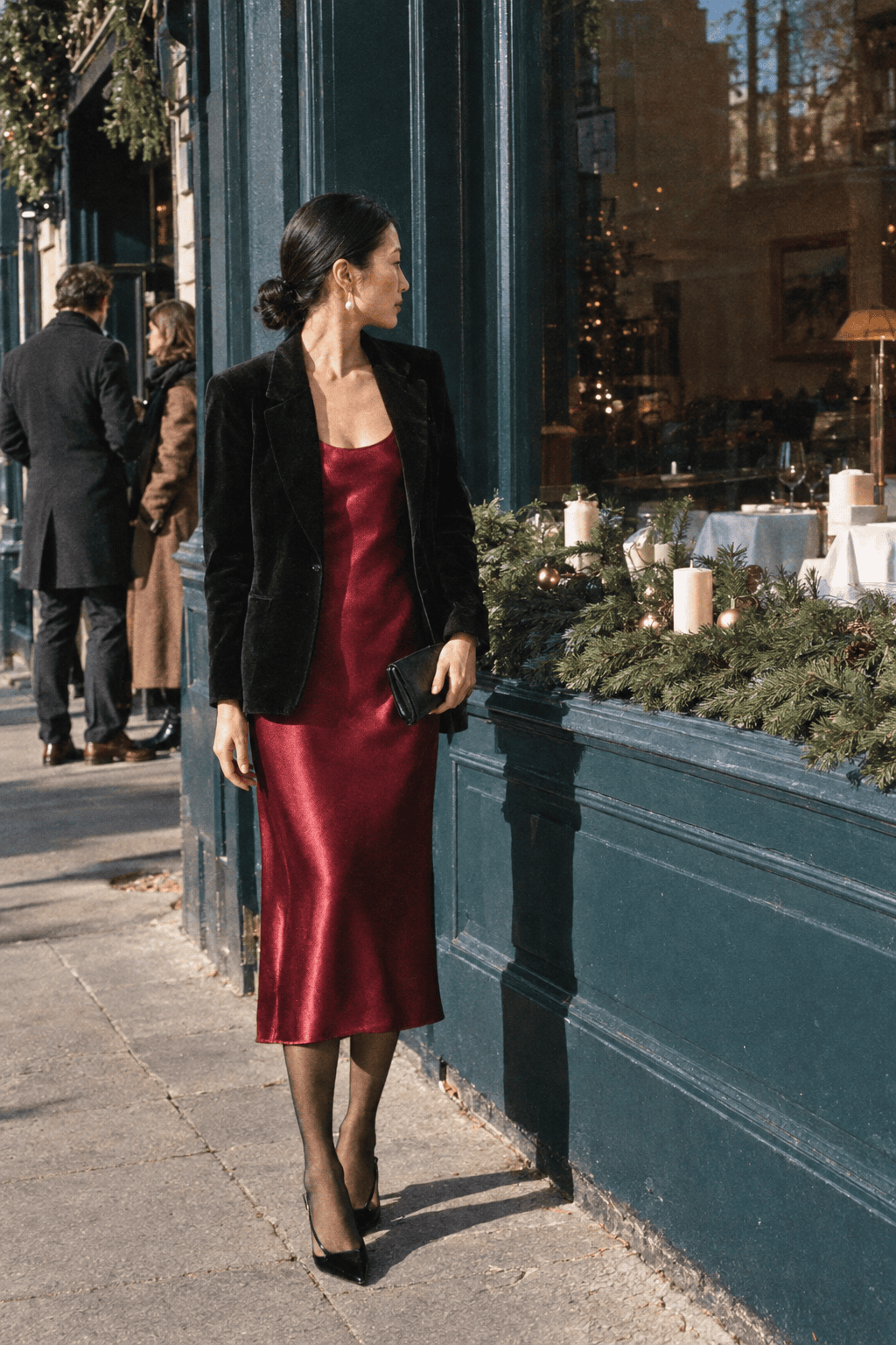 elegant red dress outfit for Christmas Eve dinner: wine silk midi dress under a black velvet blazer with pearl drop earrings