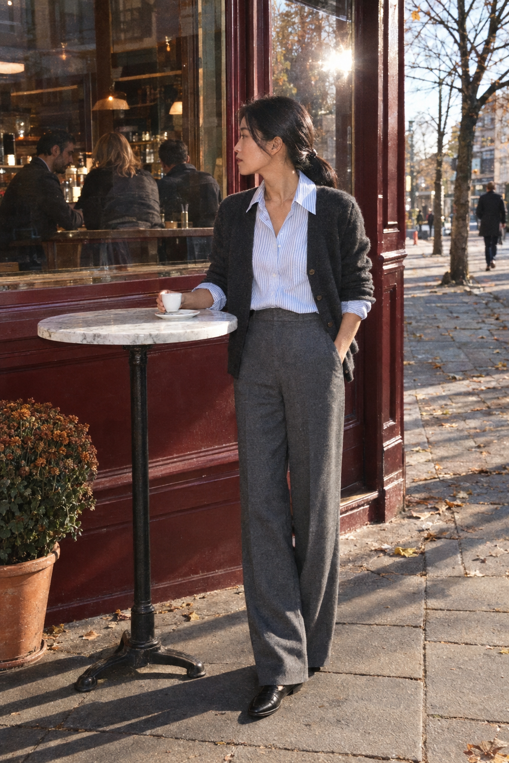 Friendsgiving outfit for helping in the kitchen: pale blue striped oversized shirt, charcoal cardigan, grey wool flannel pull-on trousers and black loafers