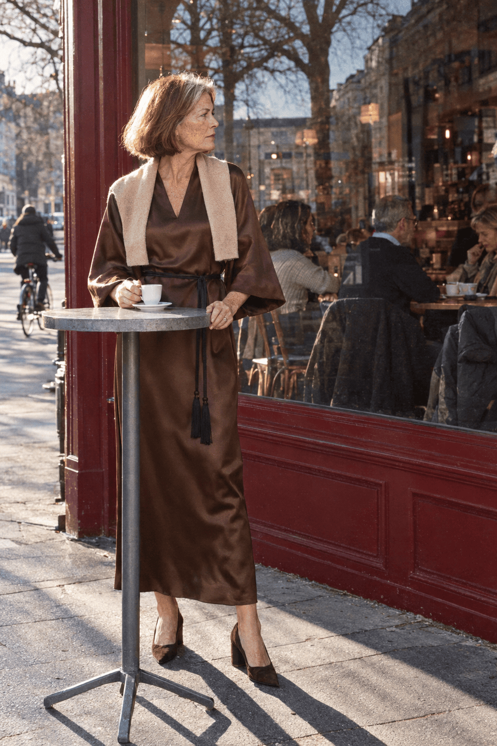 mother of the groom winter wedding outfit: long-sleeve chocolate brown satin maxi dress with a tie belt, a wheat cashmere shawl and dark brown suede pumps