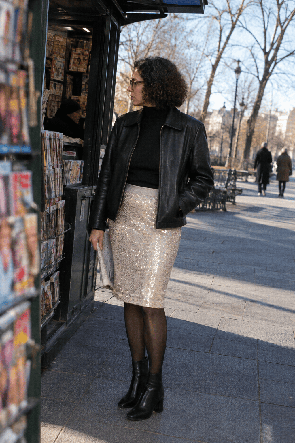 winter date night sequin skirt outfit: pale champagne knee-length sequin skirt, black cropped leather jacket, black turtleneck, black tights and ankle boots