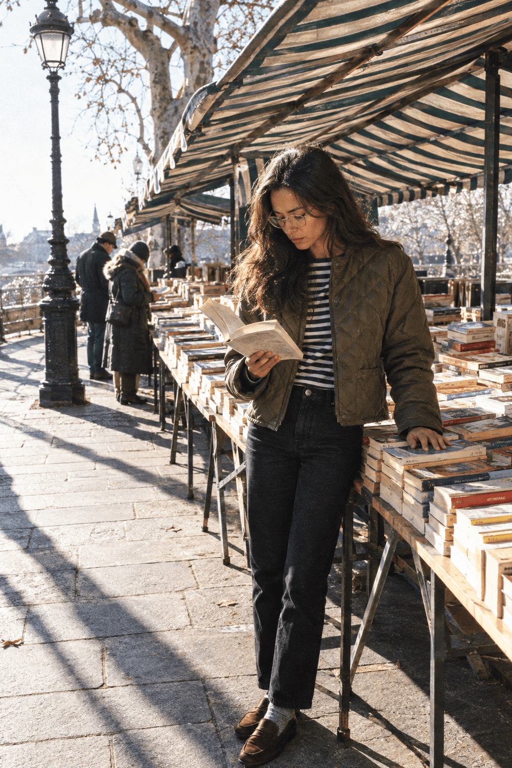 casual winter outfit: cropped olive quilted jacket, navy and ecru Breton striped top, black jeans and brown suede penny loafers