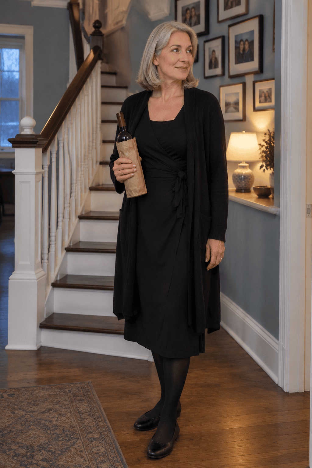 family dinner outfit for women over 60: black cashmere wrap dress with black tights and flats under a long black cashmere duster cardigan