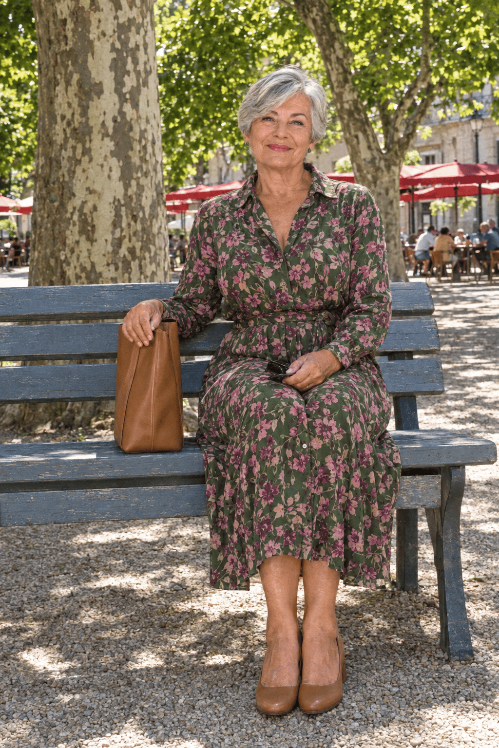 birthday lunch outfit for women in their 70s: belted forest green floral midi shirt dress with long sleeves, tan block-heel pumps and a cognac leather shoulder bag