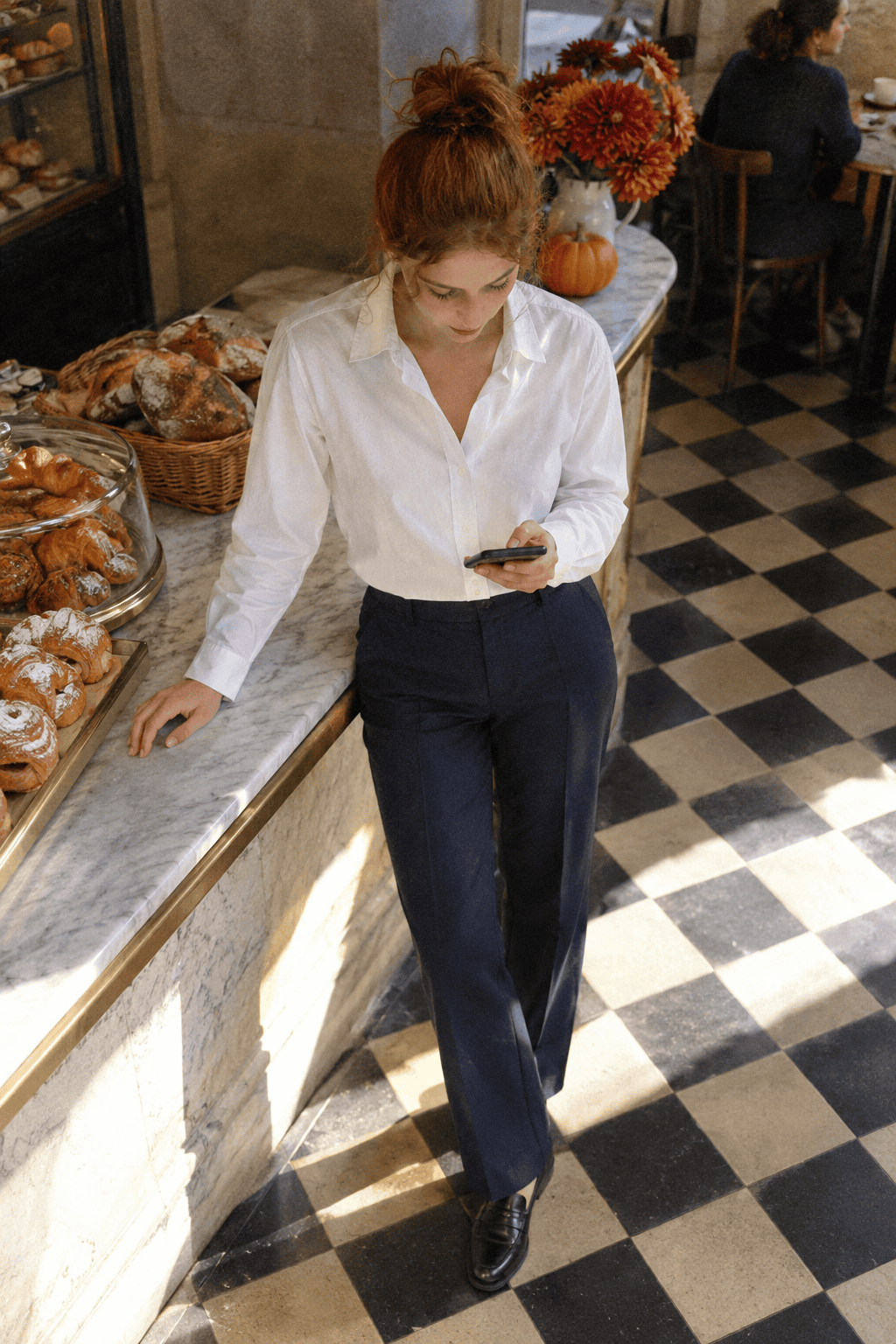 Massimo Dutti shirt review: woman in a white cotton poplin shirt tucked into navy wool trousers