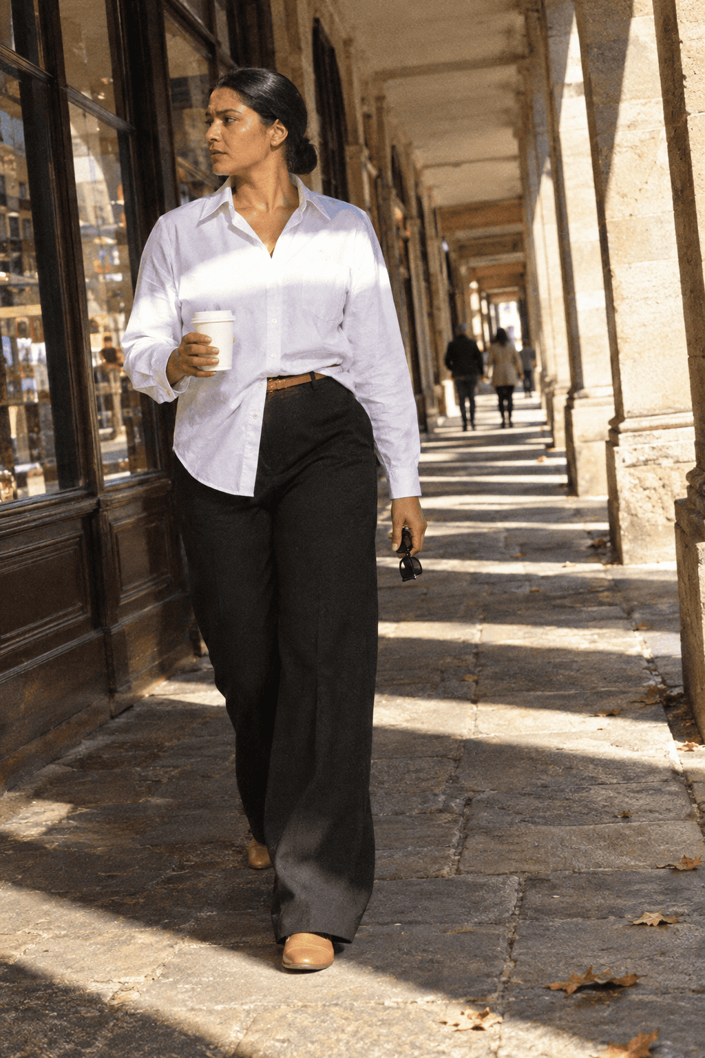 Old money clothing brands: Everlane white oxford shirt and black wide-leg trousers
