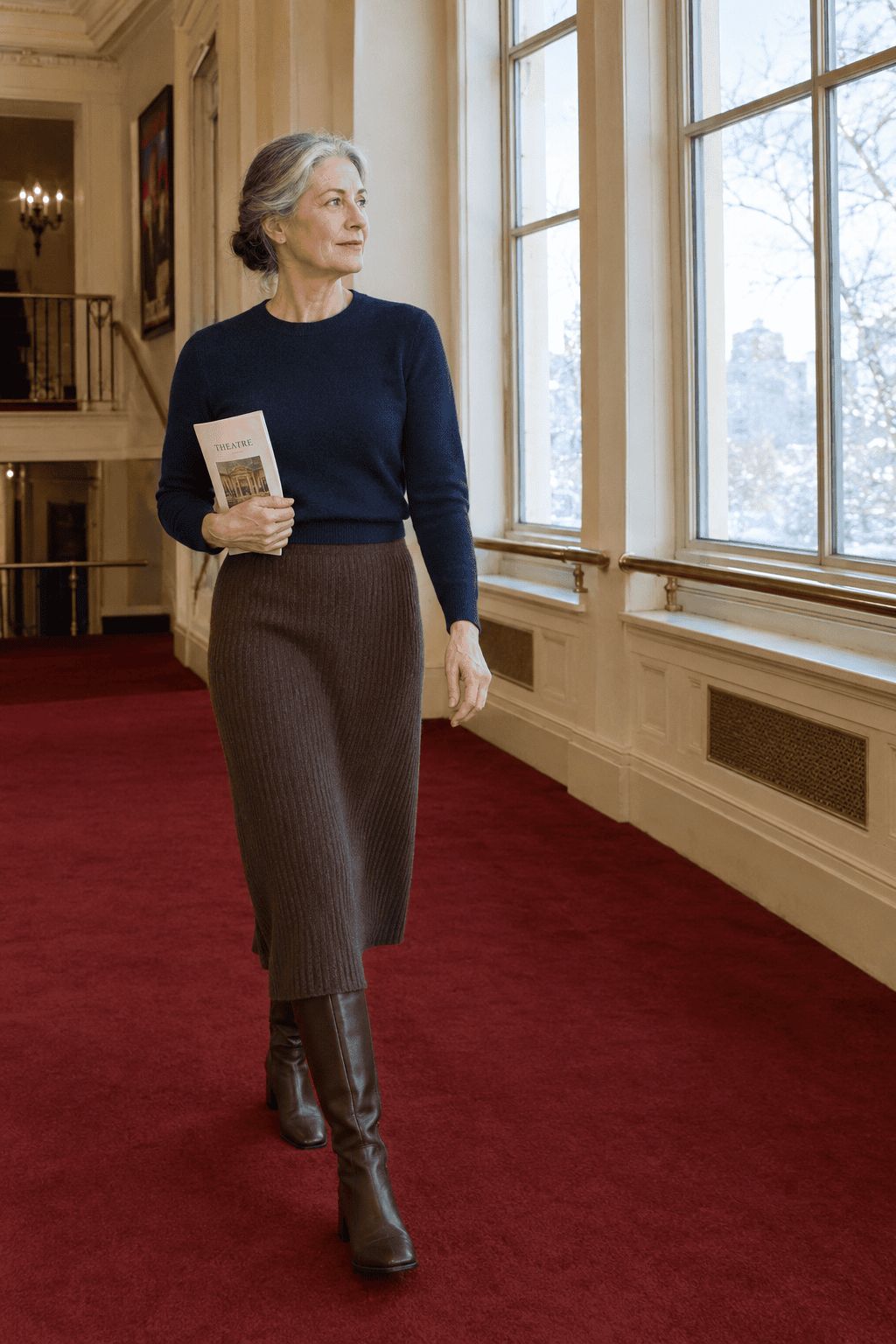 theatre matinee outfit for women over 60: navy cashmere sweater tucked into a brown cashmere rib midi skirt with brown leather knee boots