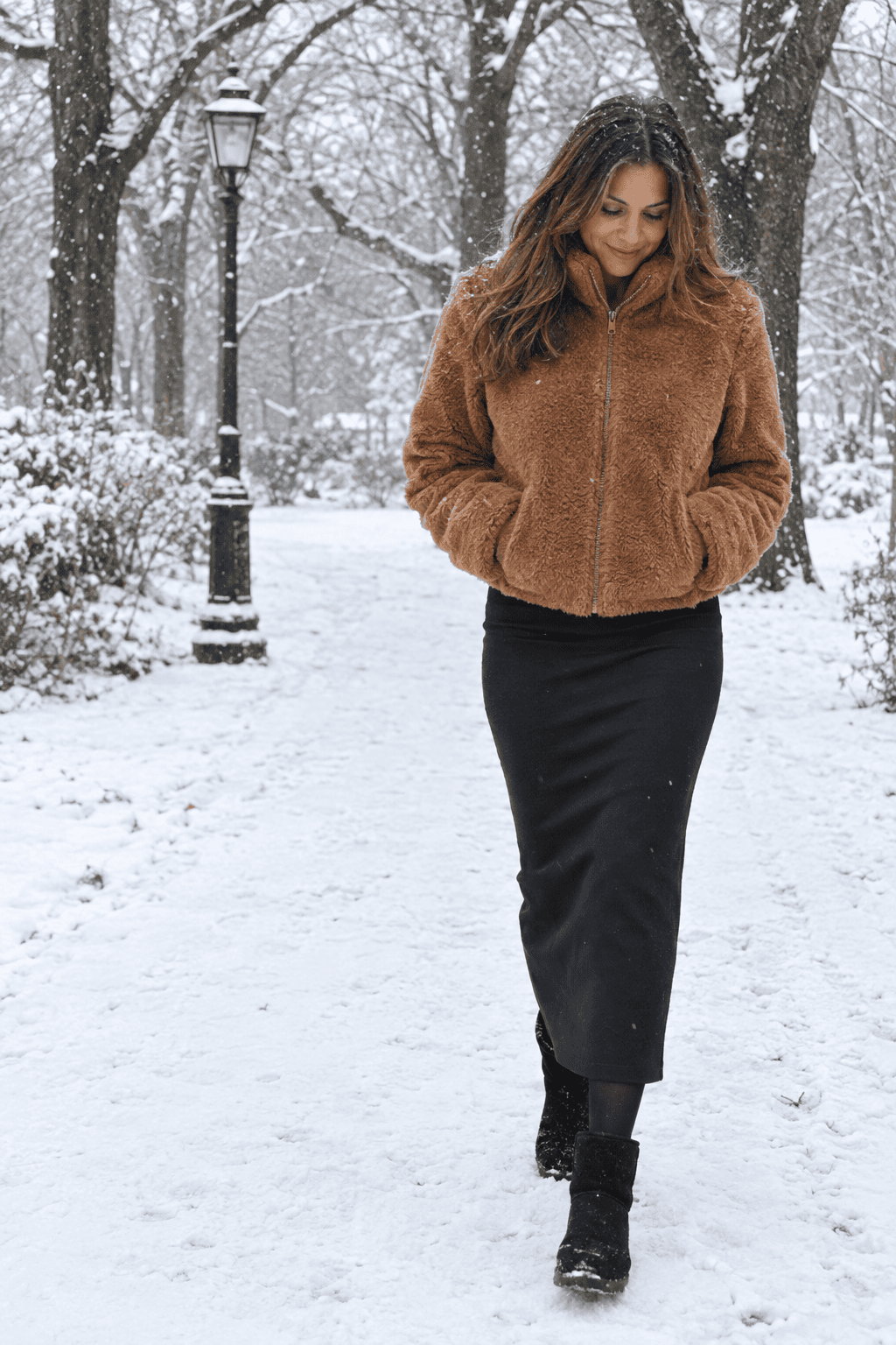 maxi skirt outfit for snowy winter days: black ponte maxi skirt with a cropped cognac faux shearling jacket and black waterproof snow boots