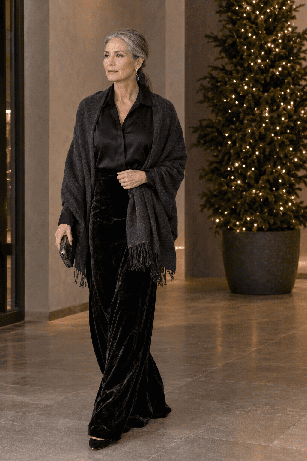 mother of the bride black-tie winter wedding outfit: black silk notch-collar blouse tucked into a black velvet maxi skirt with a charcoal cashmere wrap over the shoulders