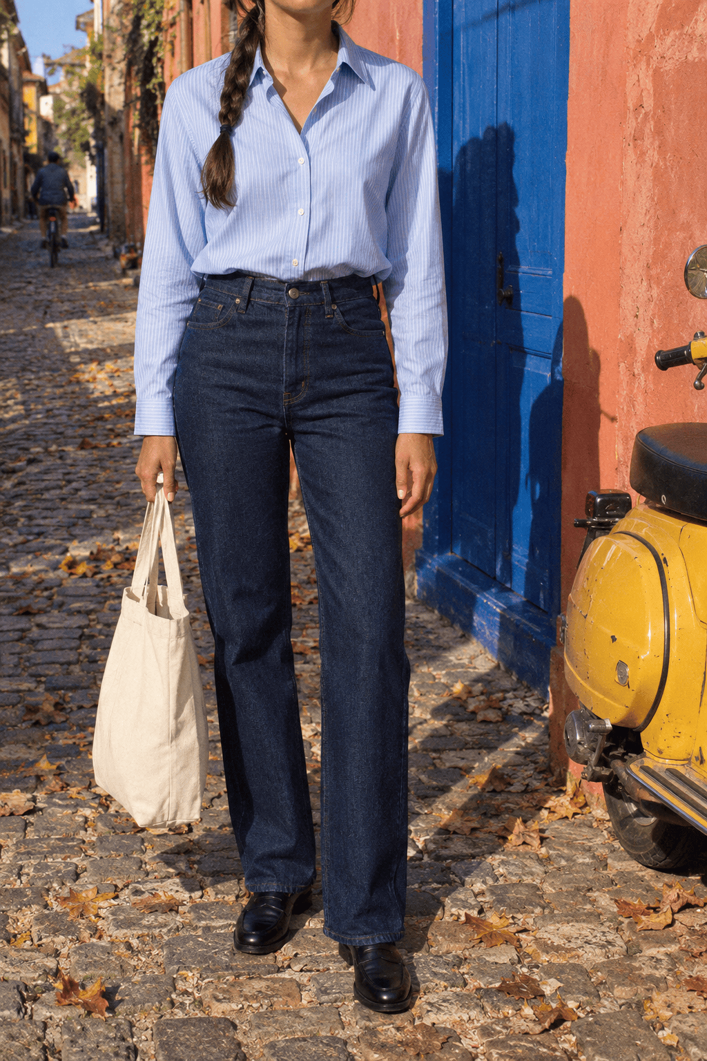 Massimo Dutti jeans review: woman in dark blue straight-leg jeans, a pale blue linen shirt and black loafers