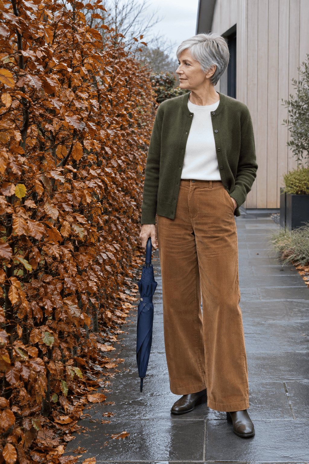 how to style a cardigan over 60 with corduroy: mossy olive green cashmere crewneck cardigan worn open with gingerbread wide-leg corduroy trousers