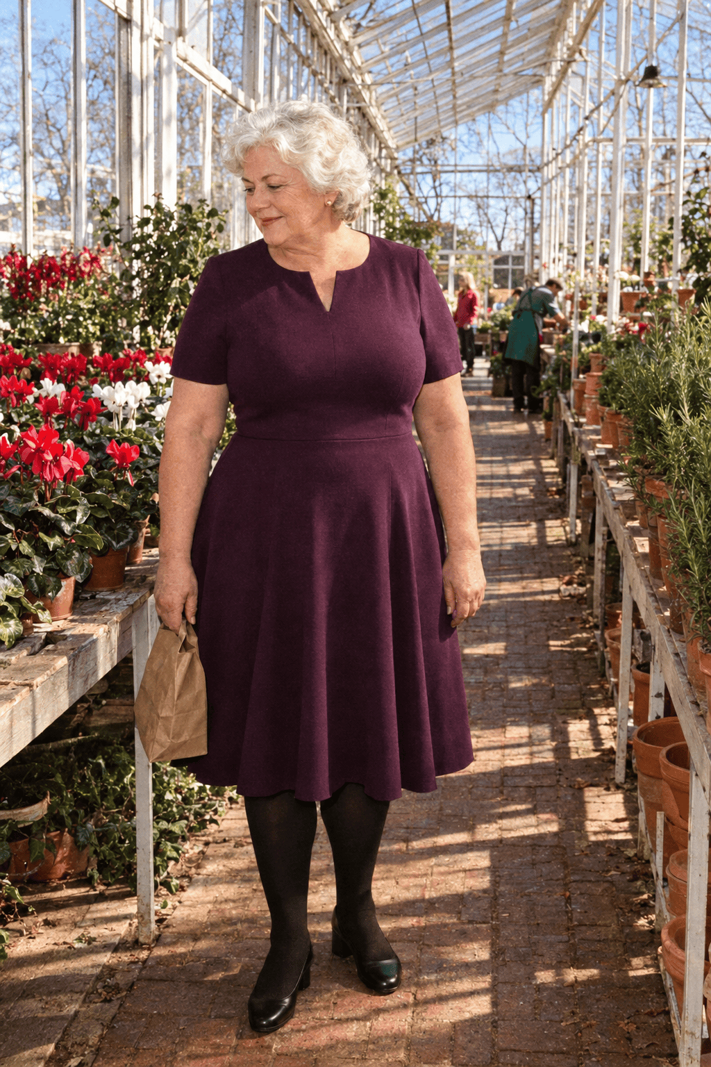 plus size family dinner outfit for women in their 70s: plum short-sleeve ponte fit-and-flare midi dress, black opaque tights and black block-heel pumps