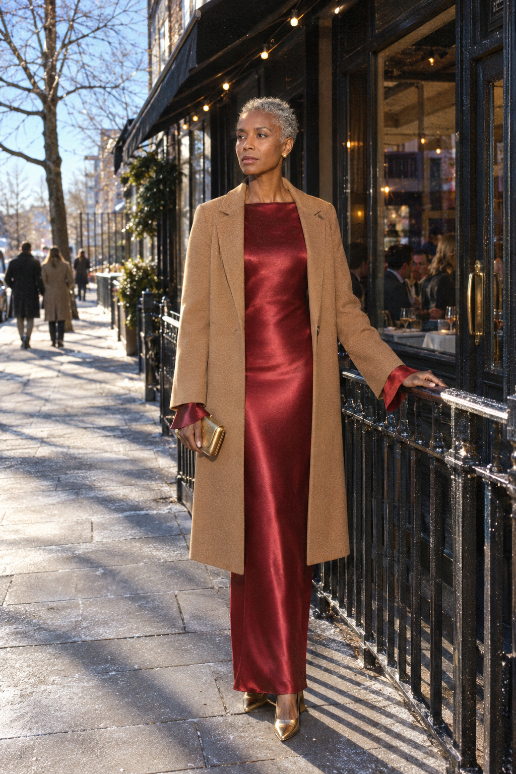 red dress outfit for New Year's Eve: wine silk long-sleeve maxi dress with bell sleeves under a dark camel wool topcoat