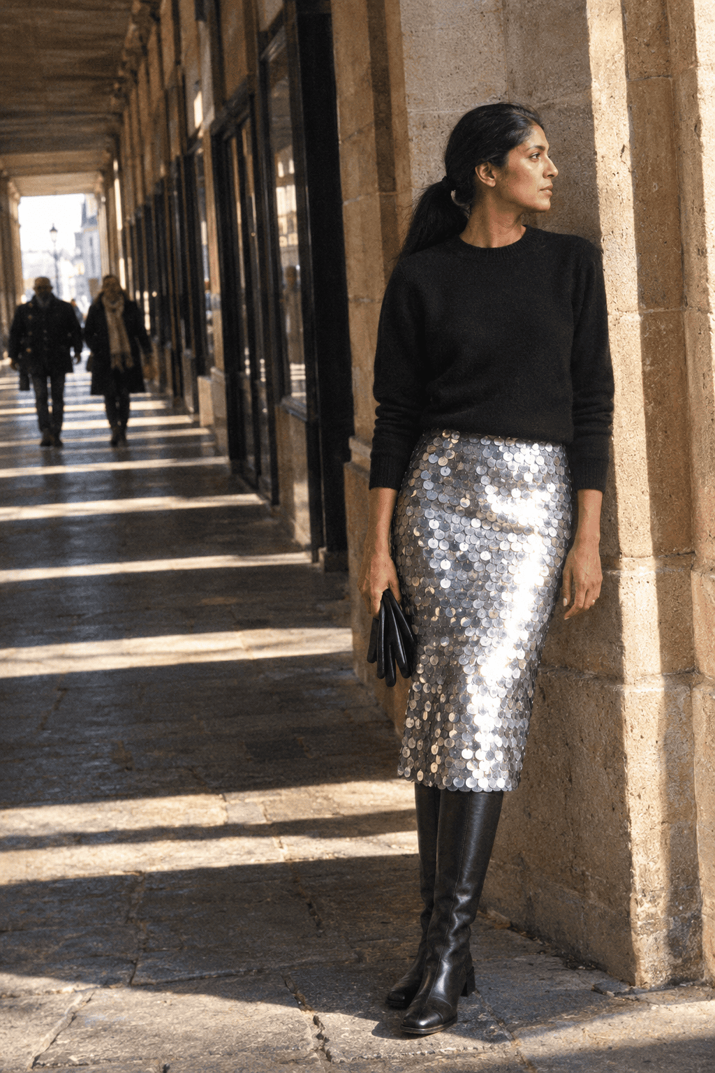 silver sequin midi skirt outfit with black opaque tights, black leather knee-high boots and a black cashmere crewneck sweater